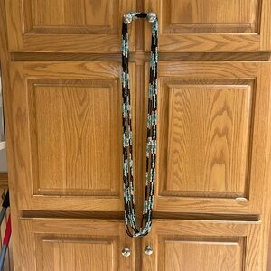 Set of 7 Black, Clear, and Carolina Panther Blue Necklaces.